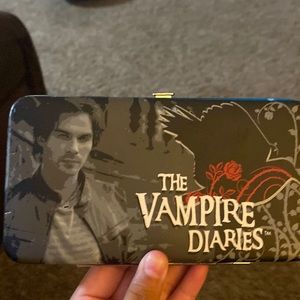 A vampire diaries bag clutch with Damon on the front of it